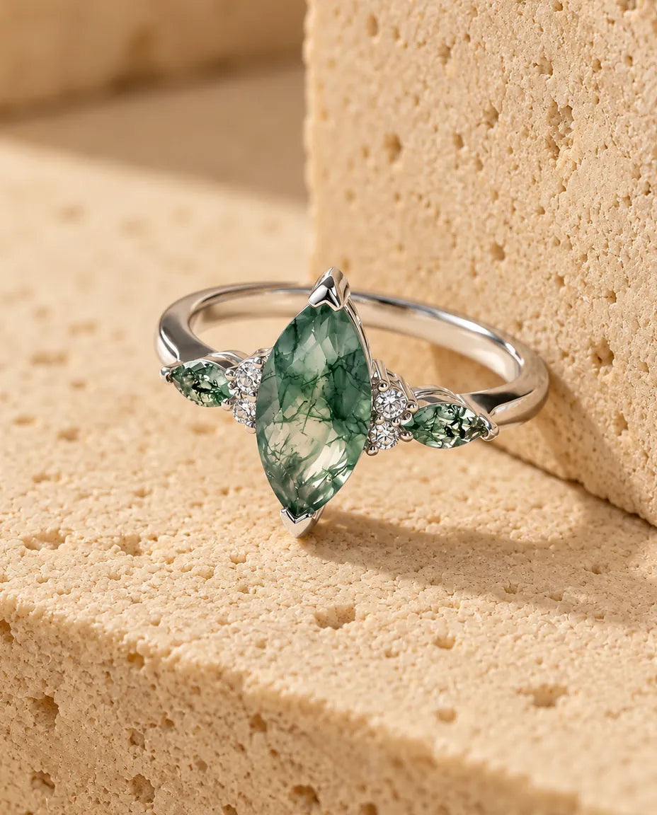 Anillo de ágata musgosa - expuesto sobre un bloque de travertino