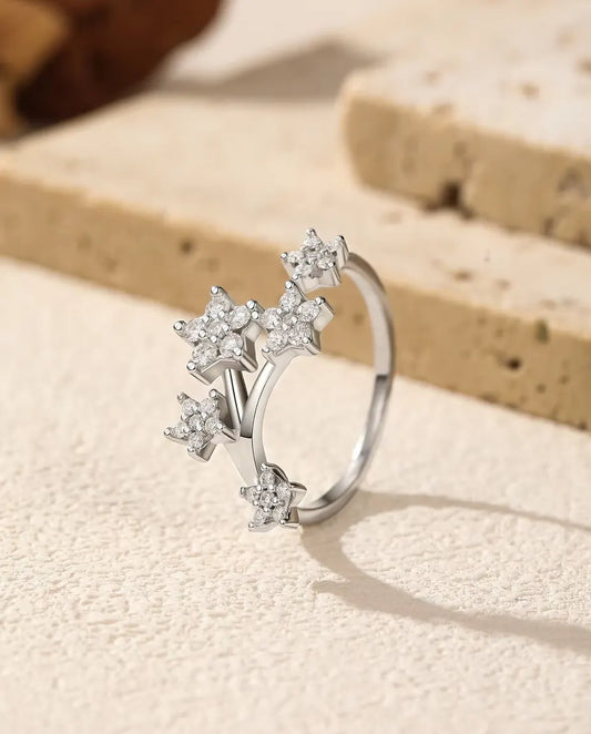 Anillo Abierto de Moissanita con Estrellas en Plata 925 - de pie sobre una superficie clara con textura