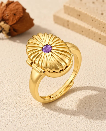 Anillo relicario ovalado con foto en color oro, con una piedra de nacimiento morada en la tapa estriada