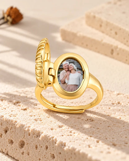 Anillo relicario ovalado abierto visto de lado, con la bisagra y la foto a la vista