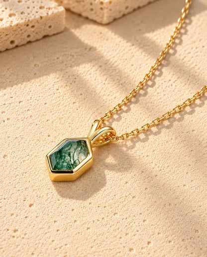 Collar de Ágata Musgosa Hexagonal en Plata 925 Chapada en Oro - tumbado sobre una superficie clara con textura