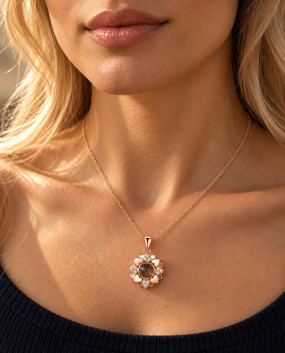 Mujer con un top azul marino de punto que lleva el collar de flor de corazones en color oro rosa