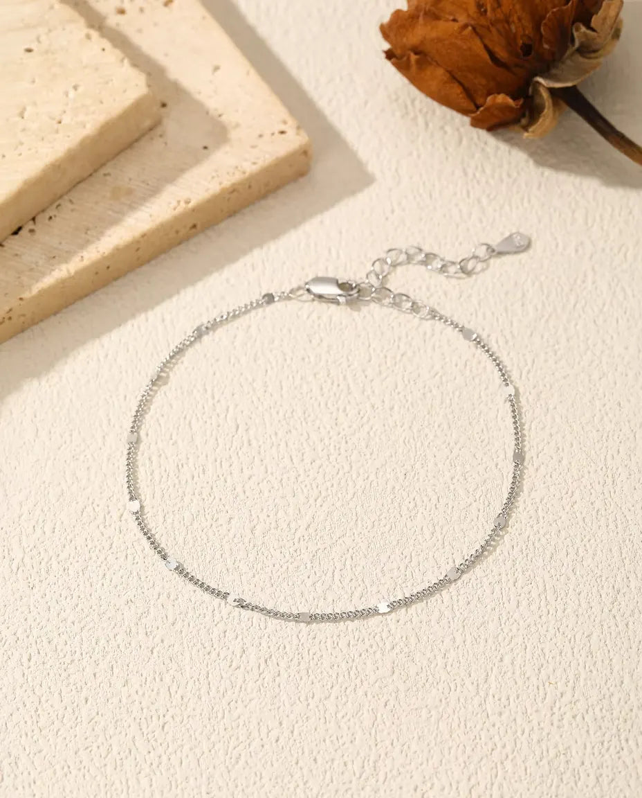 Pulsera Cadena con Lentejuelas en Plata 925 - extendida sobre una superficie clara con textura, con cierre y alargador