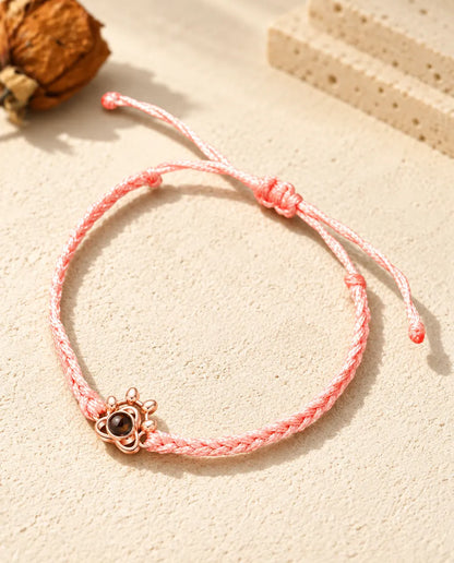 Colgante huella color oro rosa en cordón trenzado rosa con nudo corredizo ajustable