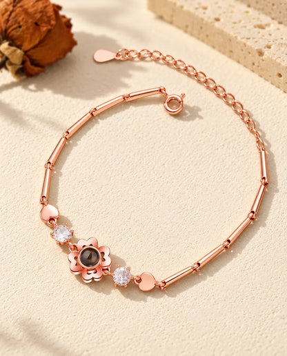 Pulsera de trébol color oro rosa con circonitas y pequeños corazones en la cadena