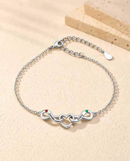 Pulsera Infinito Personalizada 2 Nombres - dos lazos infinitos en torno a un corazón y dos piedras de nacimiento - vista frontal