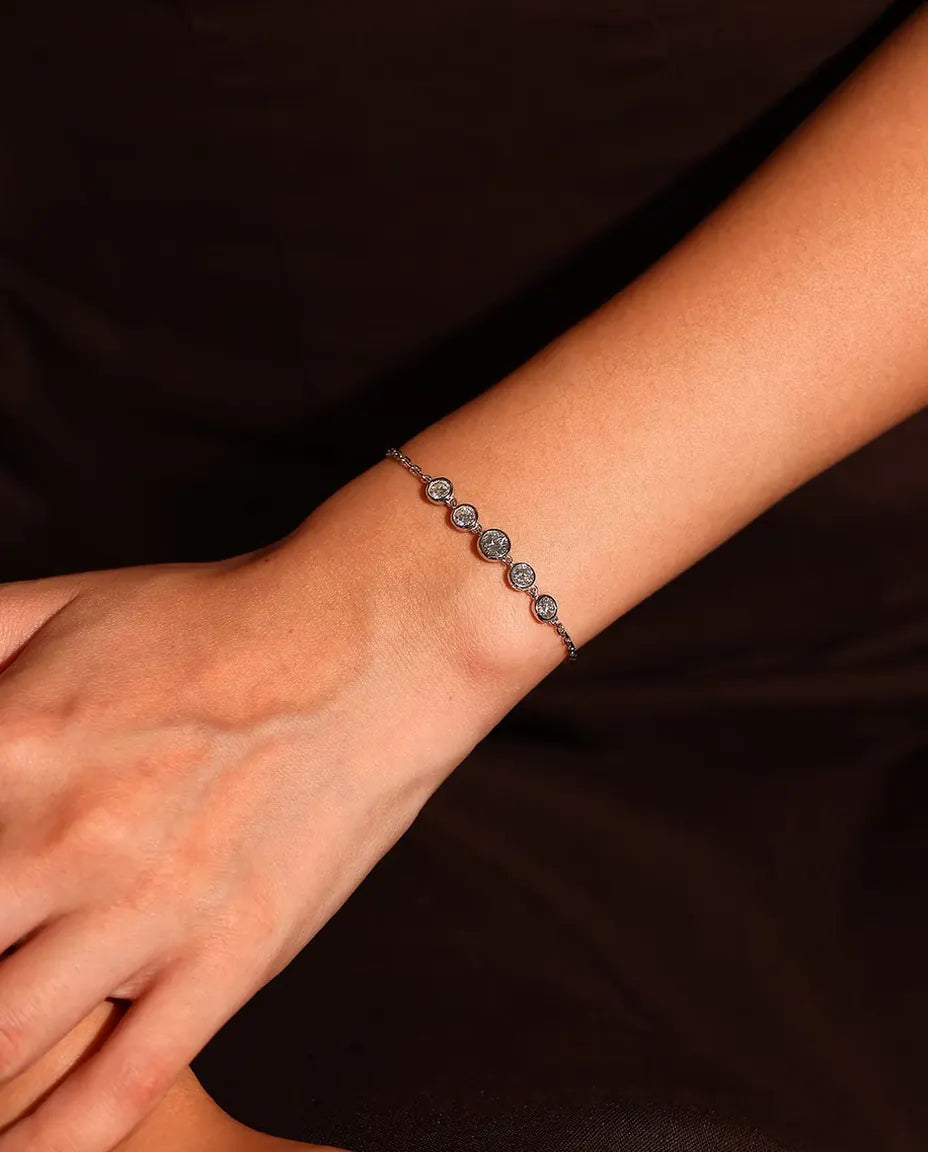 Pulsera de Moissanita en Bisel en Plata 925 - llevada en la muñeca sobre un fondo oscuro